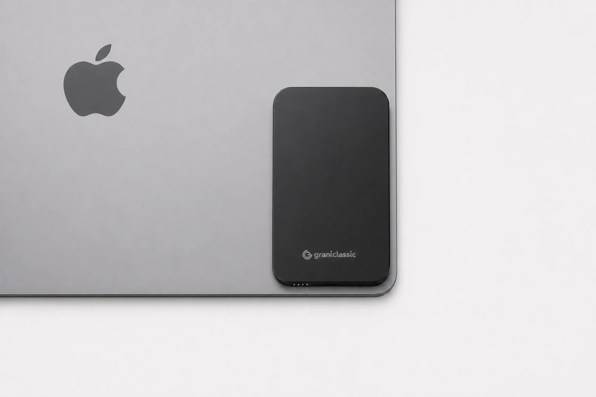 TITANSHIELD Air resting against the corner of a MacBook, the radii matching