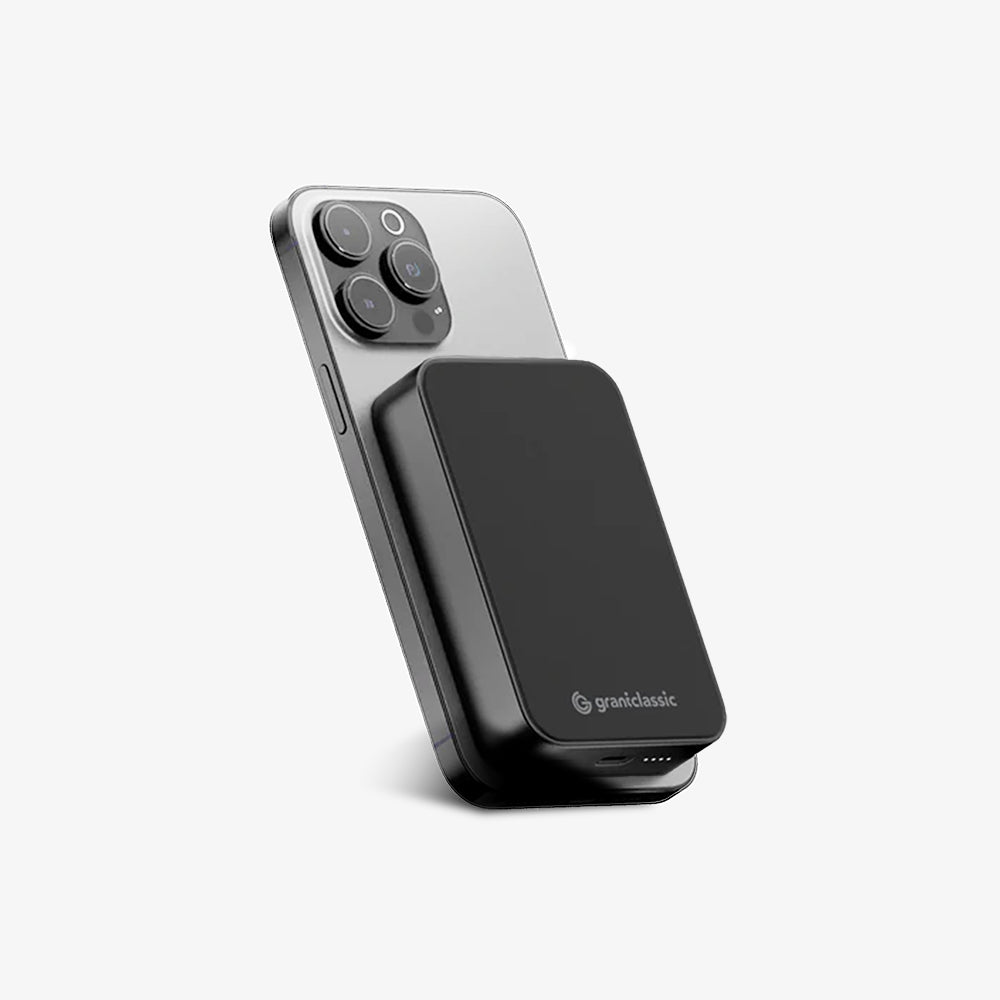 TITANSHIELD Solid-State Power Bank attached to a phone, three-quarter view | grantclassic