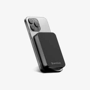 TITANSHIELD Solid-State Power Bank attached to a phone, three-quarter view | grantclassic