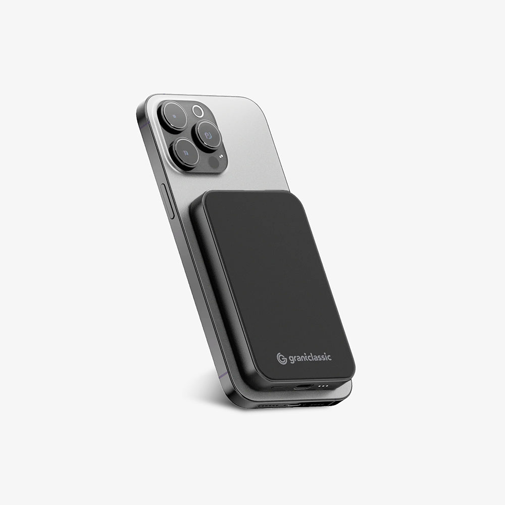 TITANSHIELD Solid-State Power Bank charging wirelessly on the back of an iPhone | grantclassic