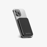 TITANSHIELD Solid-State Power Bank charging wirelessly on the back of an iPhone | grantclassic