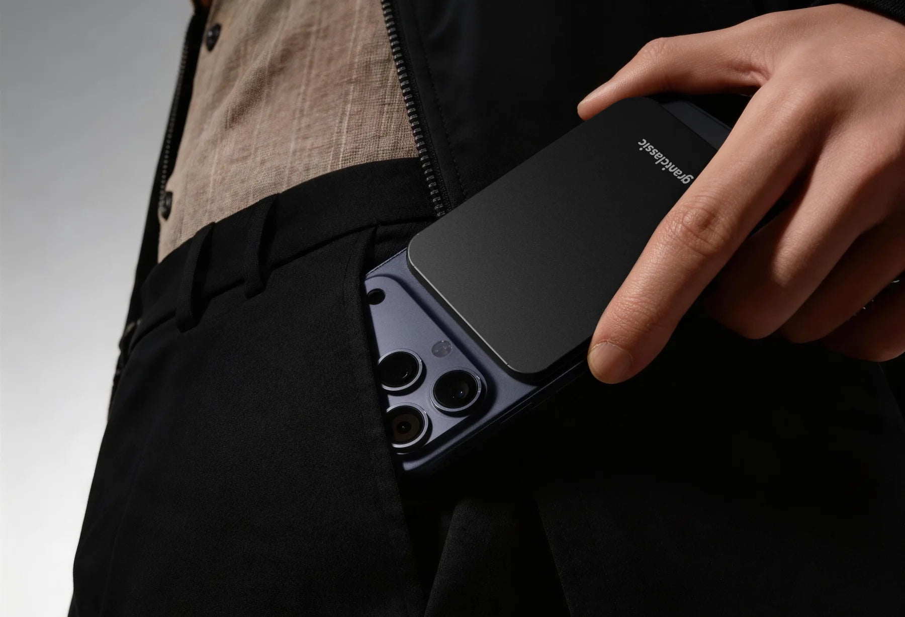 TITANSHIELD Air charging an iPhone from a jacket pocket
