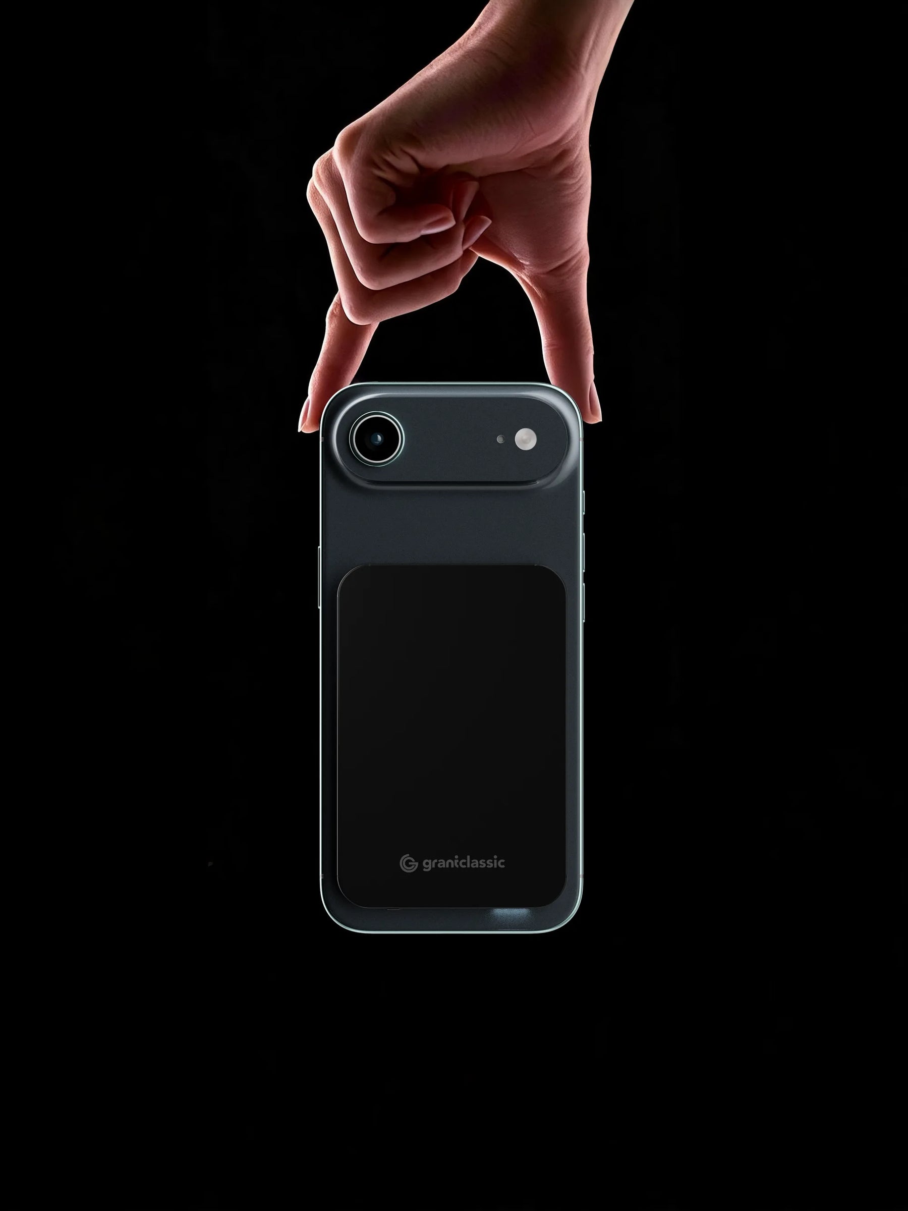 TITANSHIELD Air snapped onto the back of an iPhone, held by two fingers